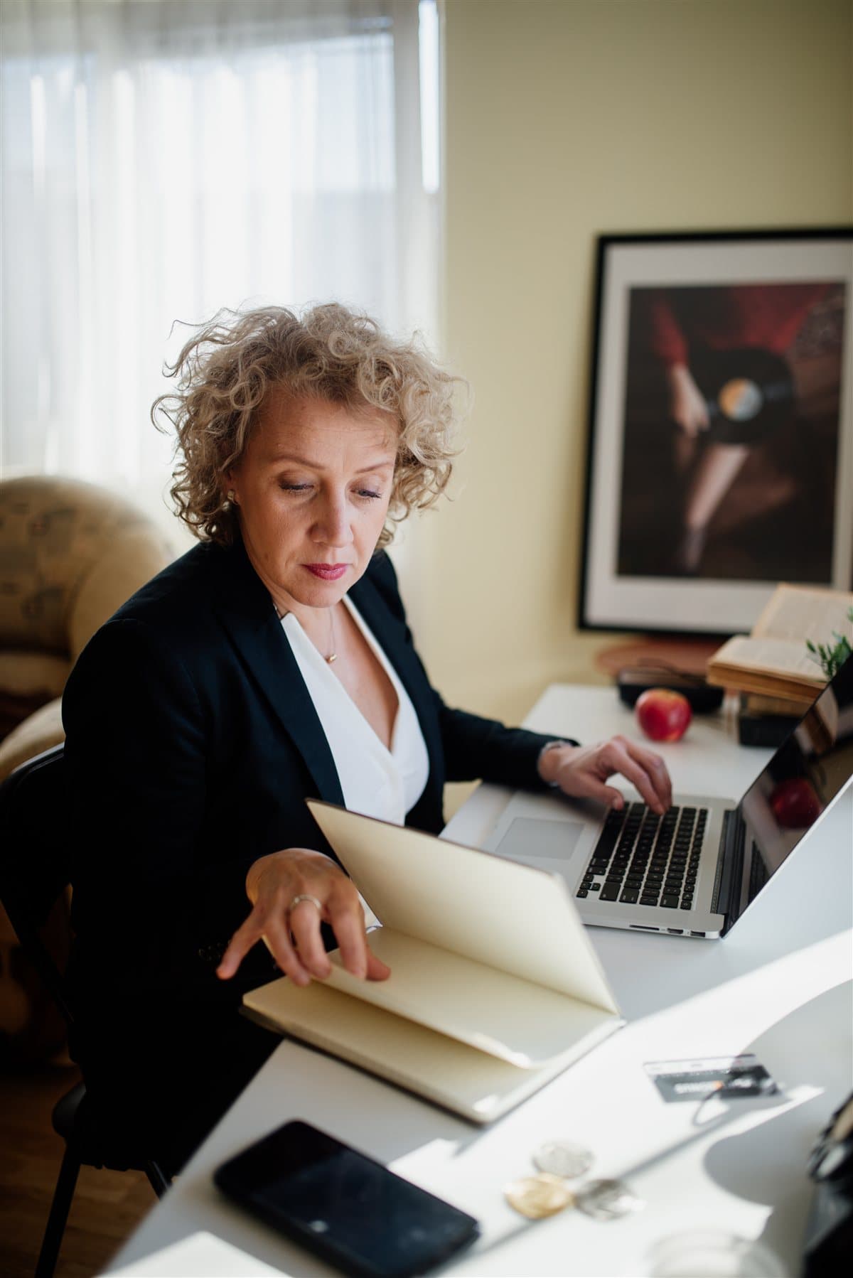 Professional reviewer running convert pdf to text workflow on laptop and paper records