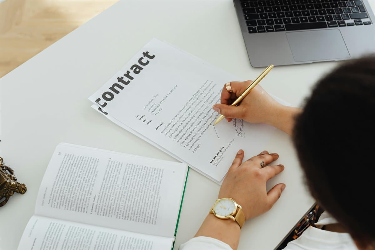 Person reviewing a contract while applying how to watermark a PDF settings in a desk workflow